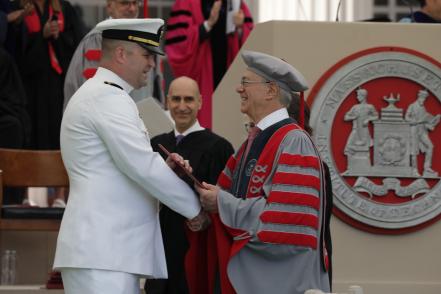 President Reif hands a diploma to one of MIT’s newest alumni