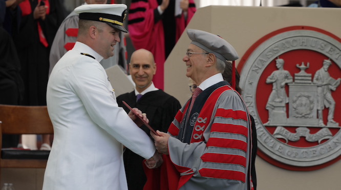 President Reif hands a diploma to one of MIT’s newest alumni